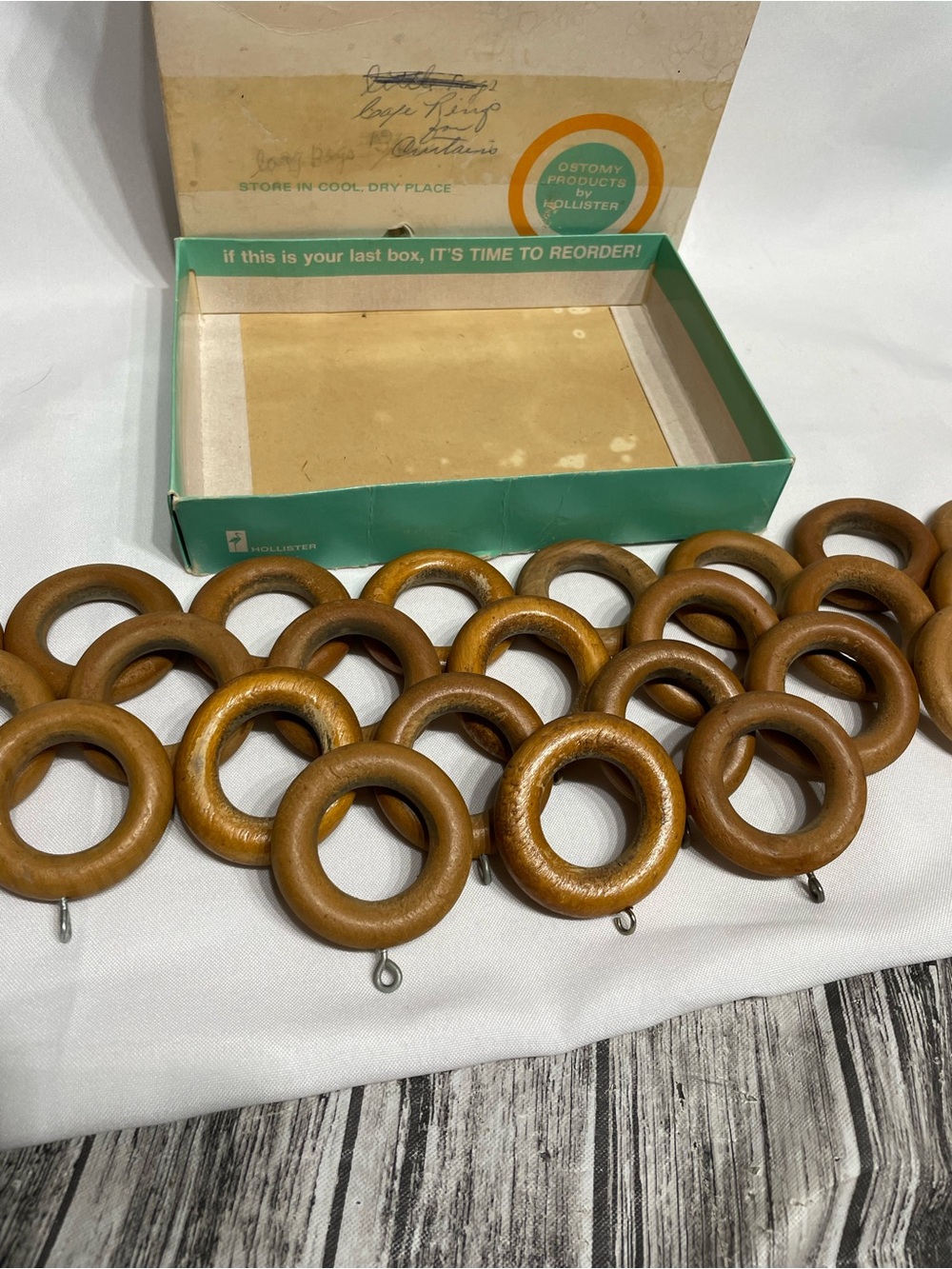 Set of 24 vintage wooden curtain rings feature metal screw eyes for drapery